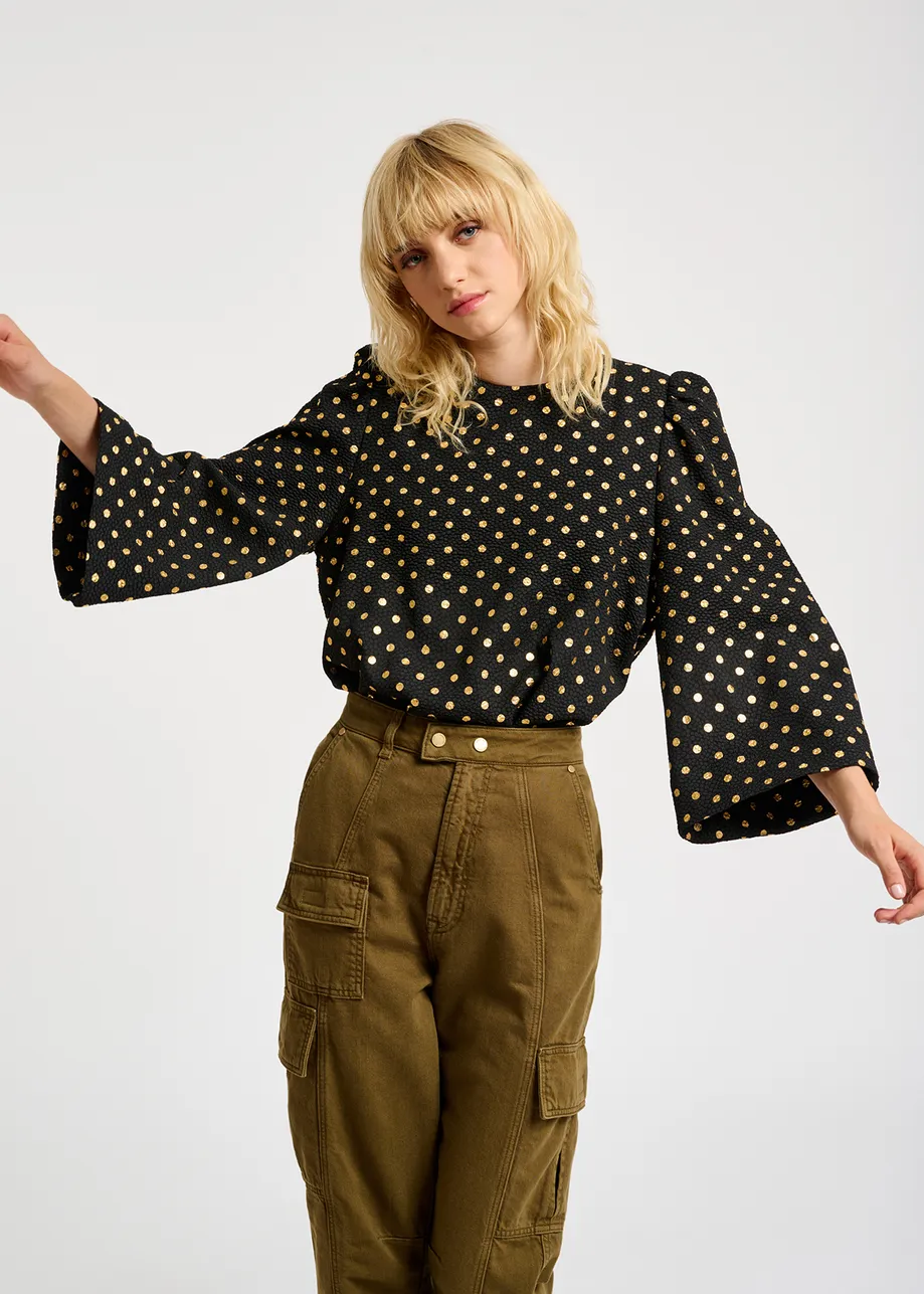 Black and gold polka-dot top with trumpet sleeves