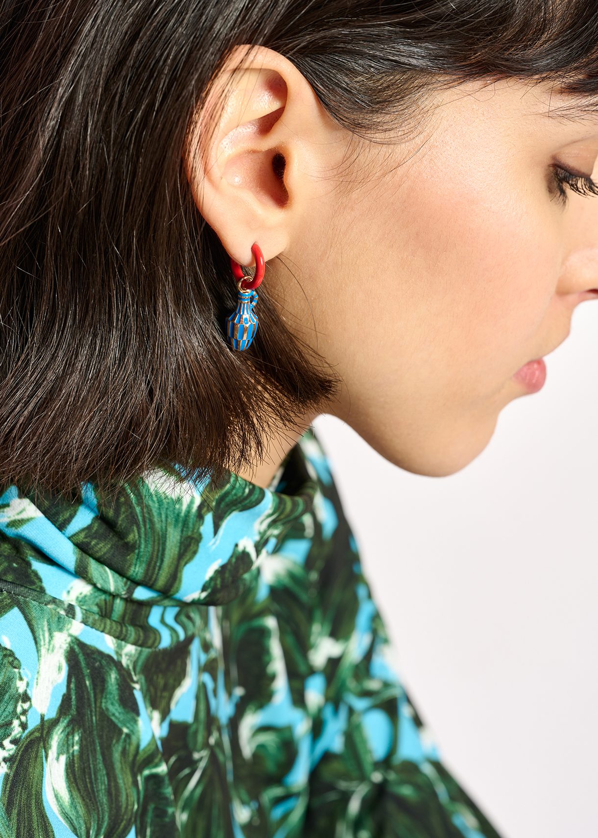 Red hoop earrings with vase and face pendants