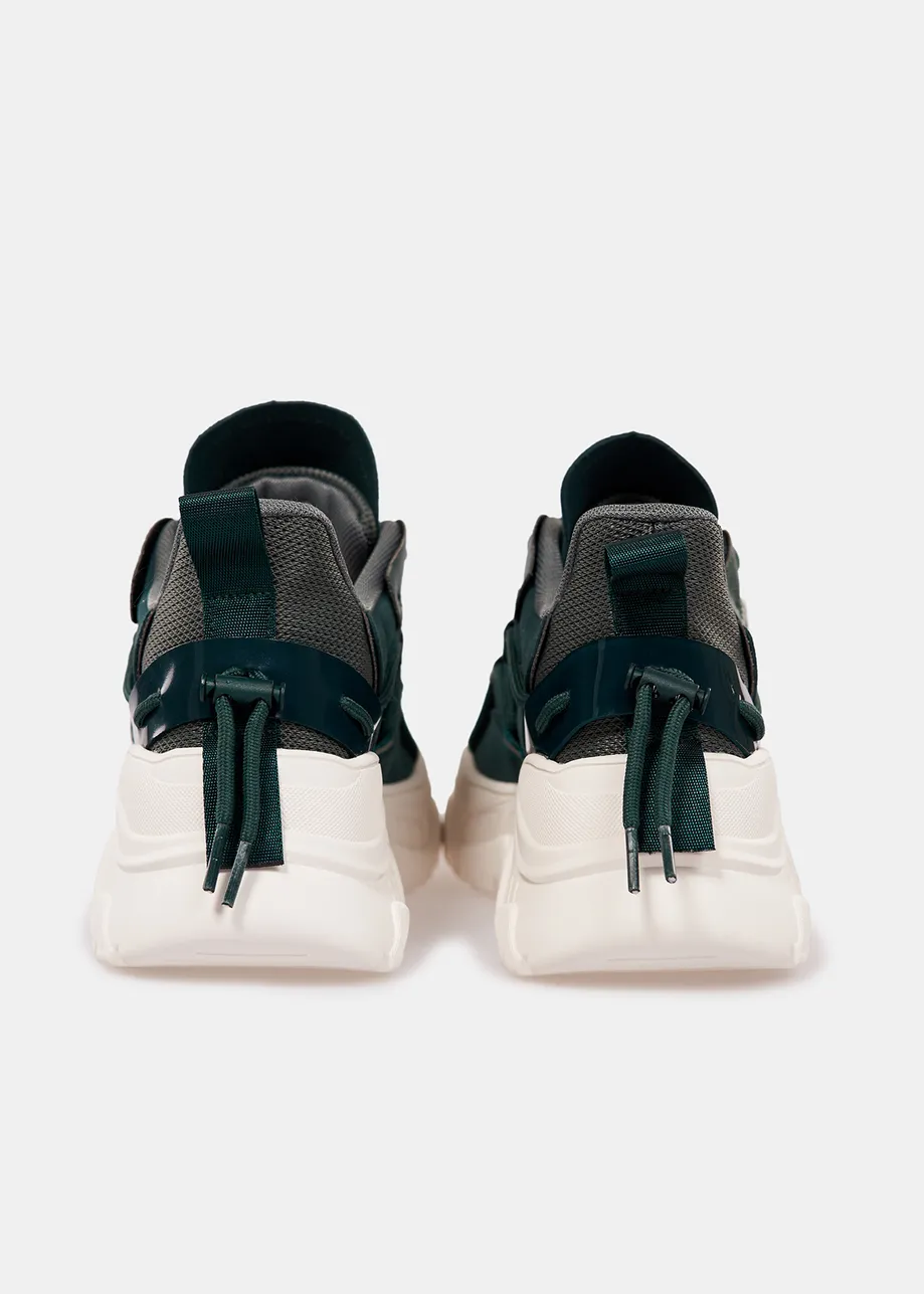 Dark green sneakers set on chunky white soles