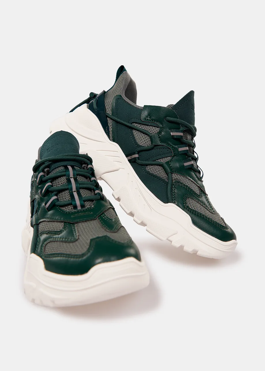 Dark green sneakers set on chunky white soles
