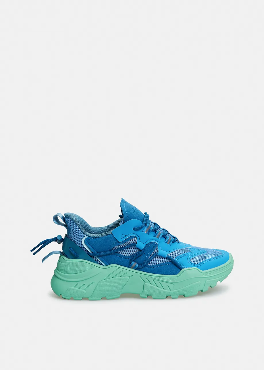 Blue sneakers set on chunky mint green soles