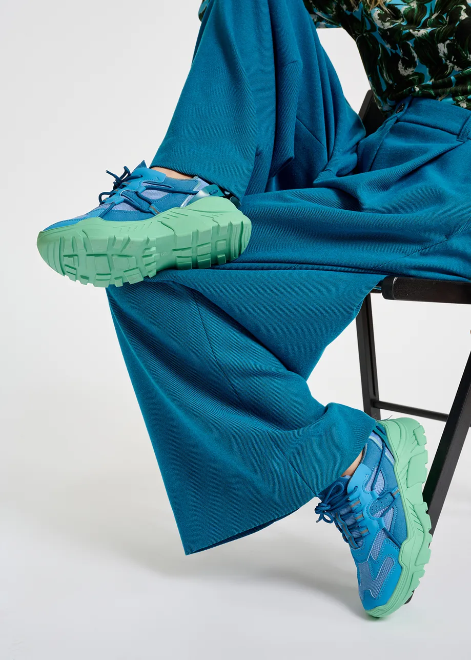 Blue sneakers set on chunky mint green soles