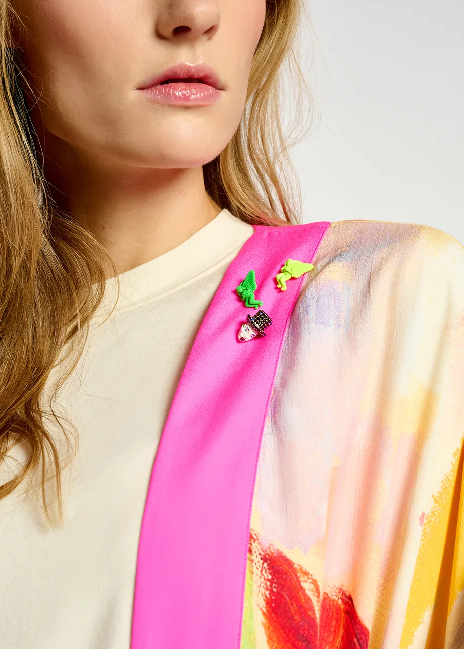 White 'The Intrigue' mask-shaped pin - collaboration with KMSKA