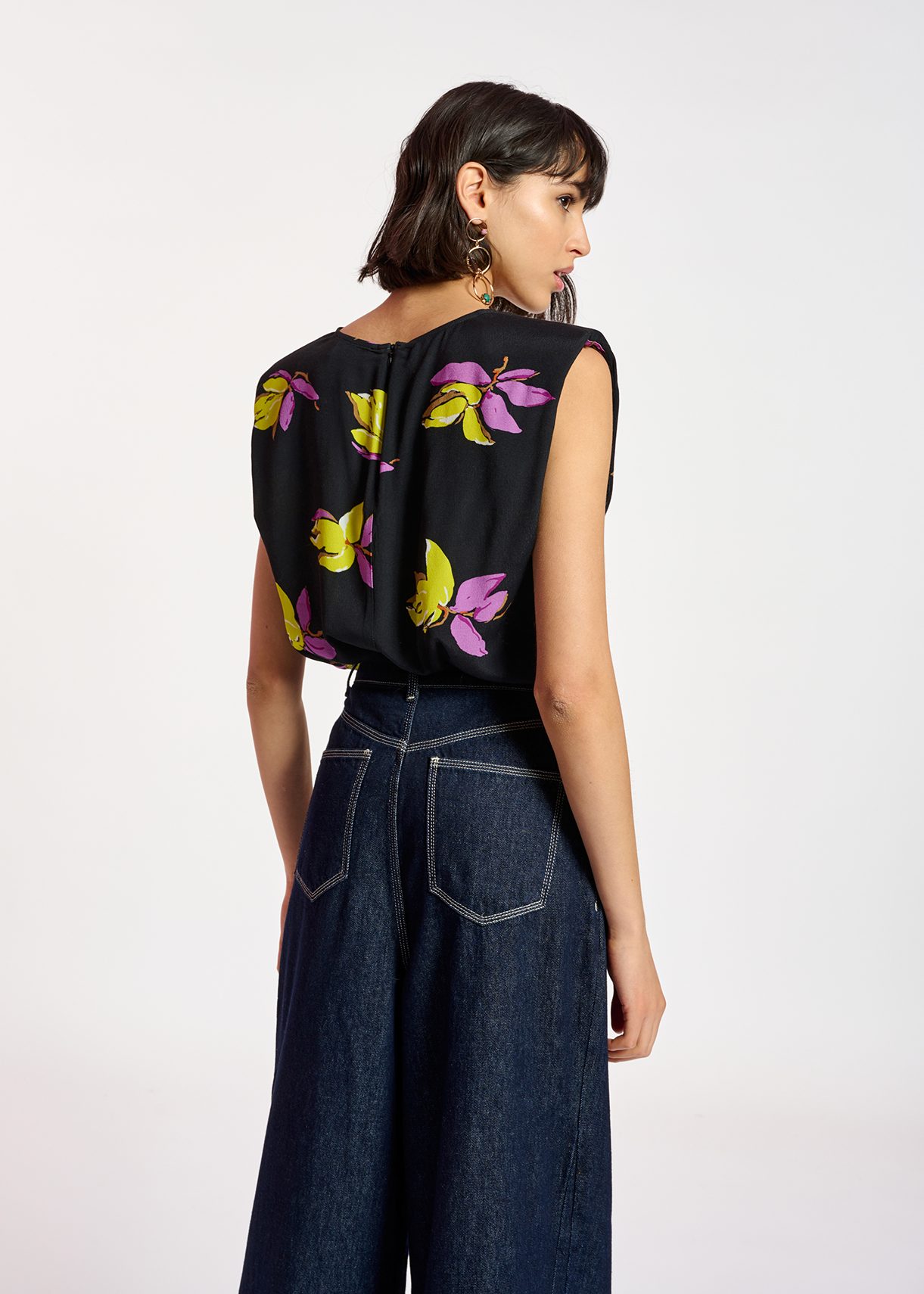 Black floral-print sleeveless top with padded shoulders