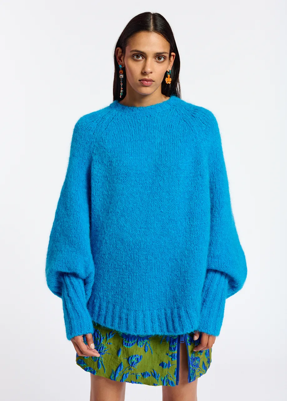 Blue knit sweater with cape effect