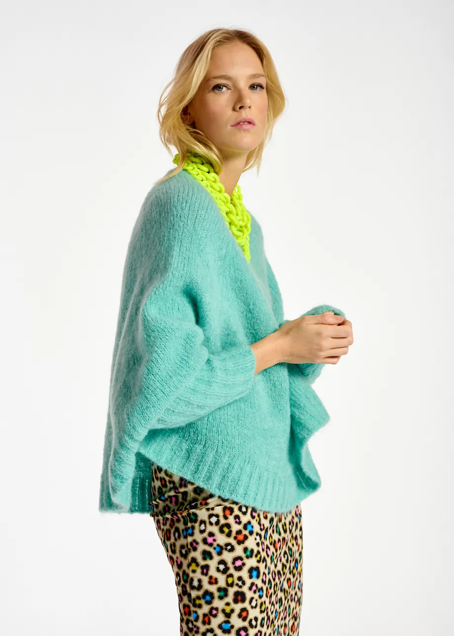 Turquoise knit sweater with cape effect