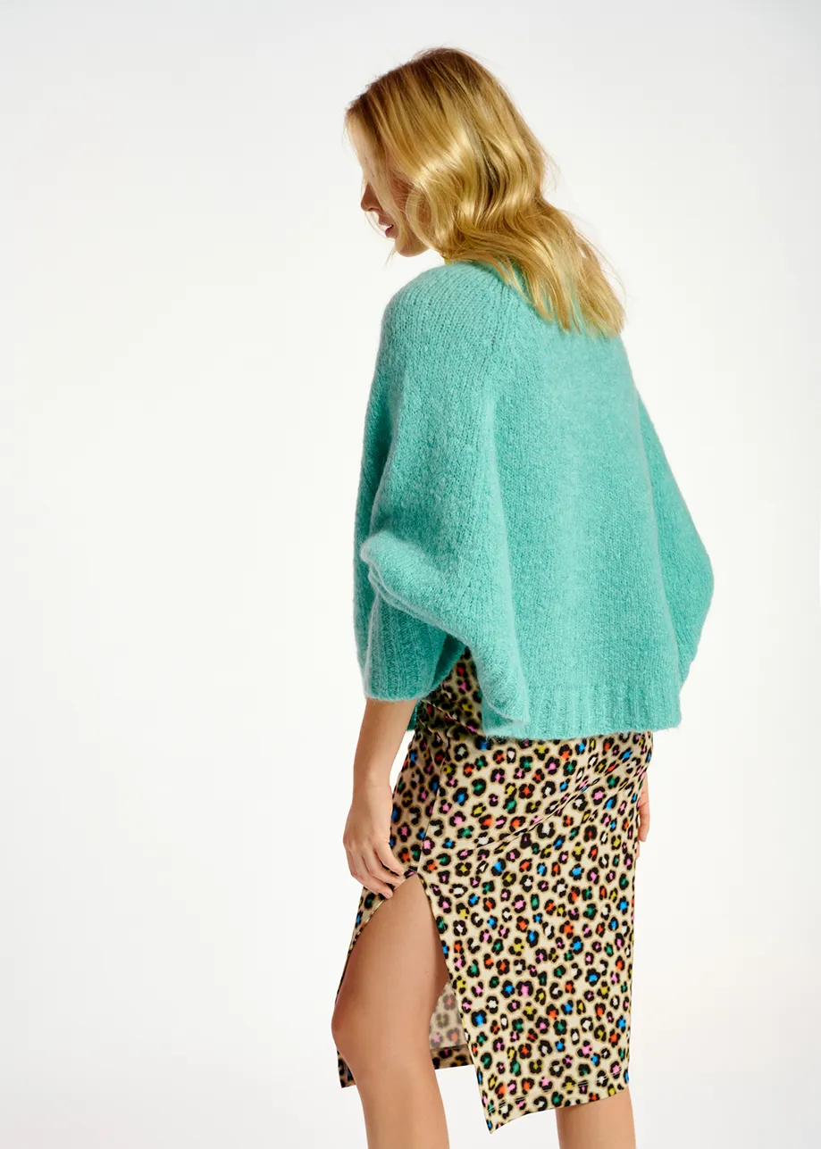 Turquoise knit sweater with cape effect