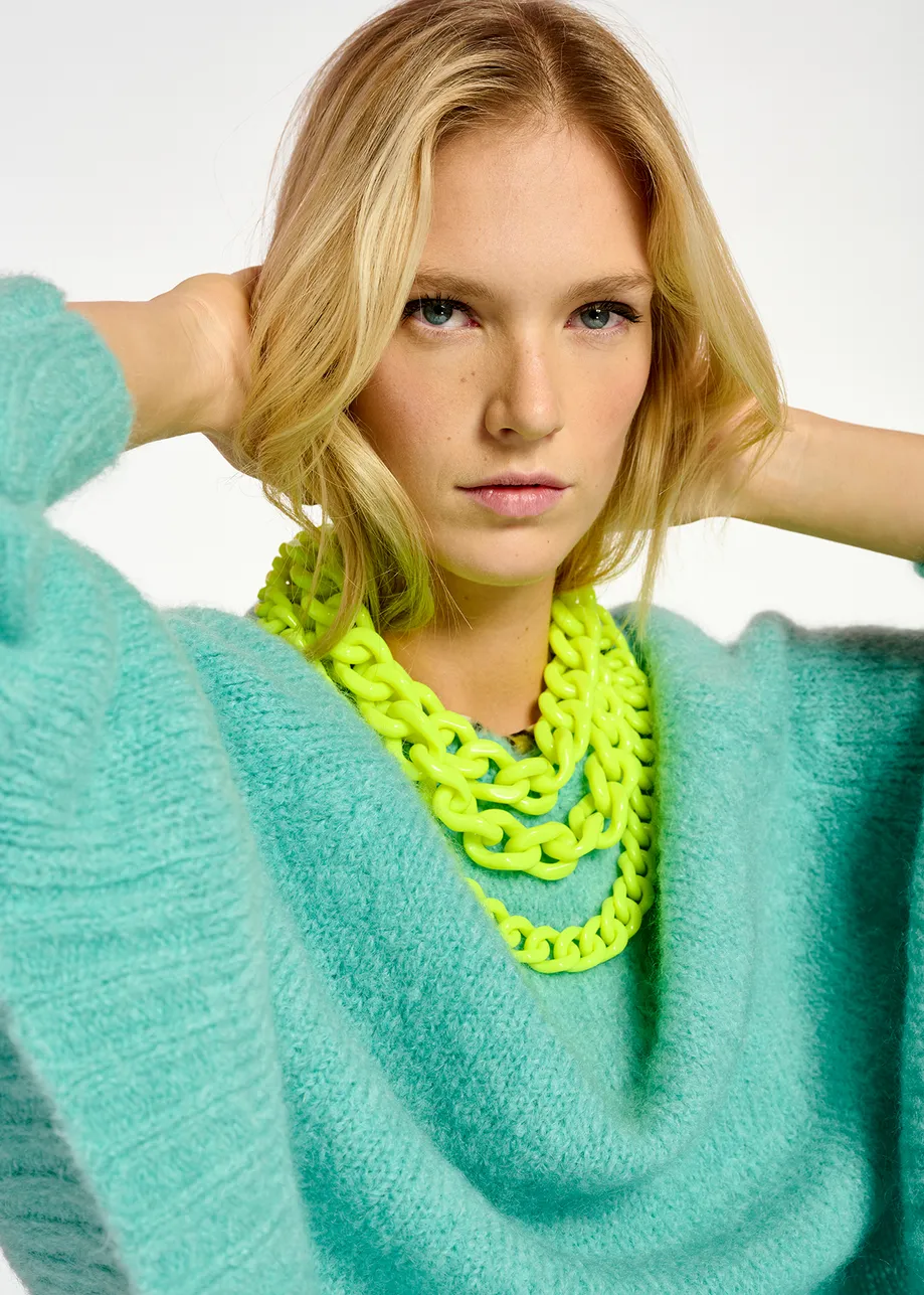 Turquoise knit sweater with cape effect
