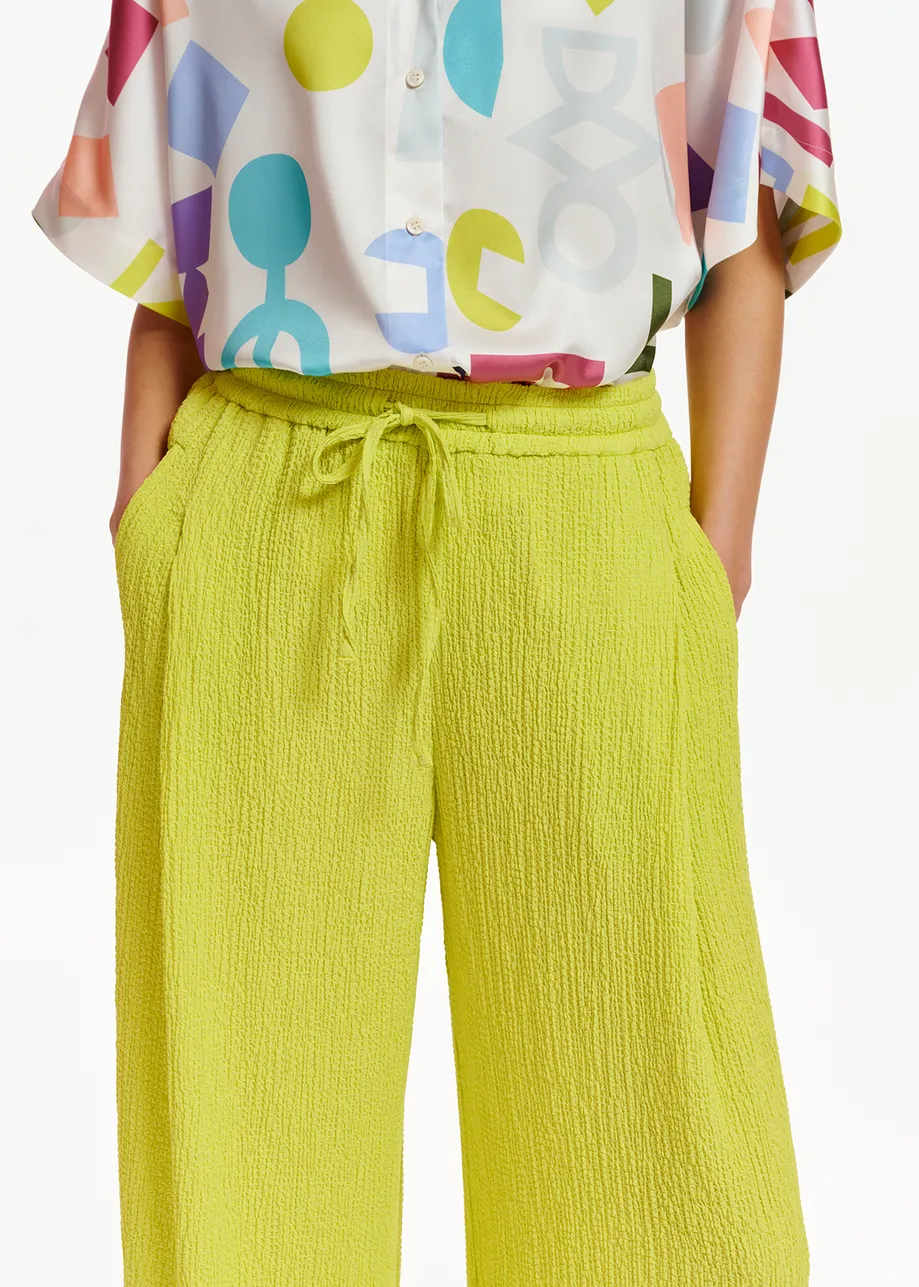 Lime green wide-leg seersucker pants