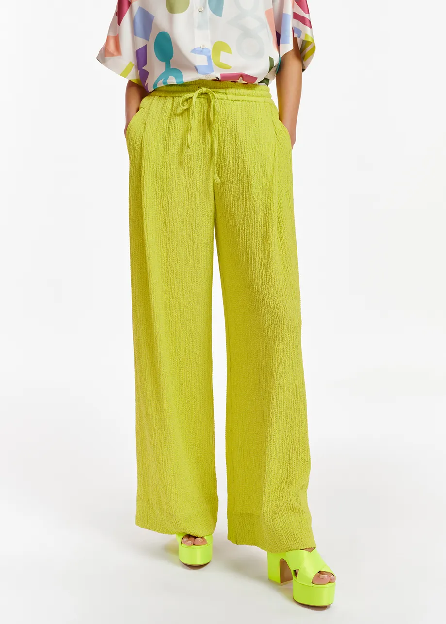 Lime green wide-leg seersucker pants