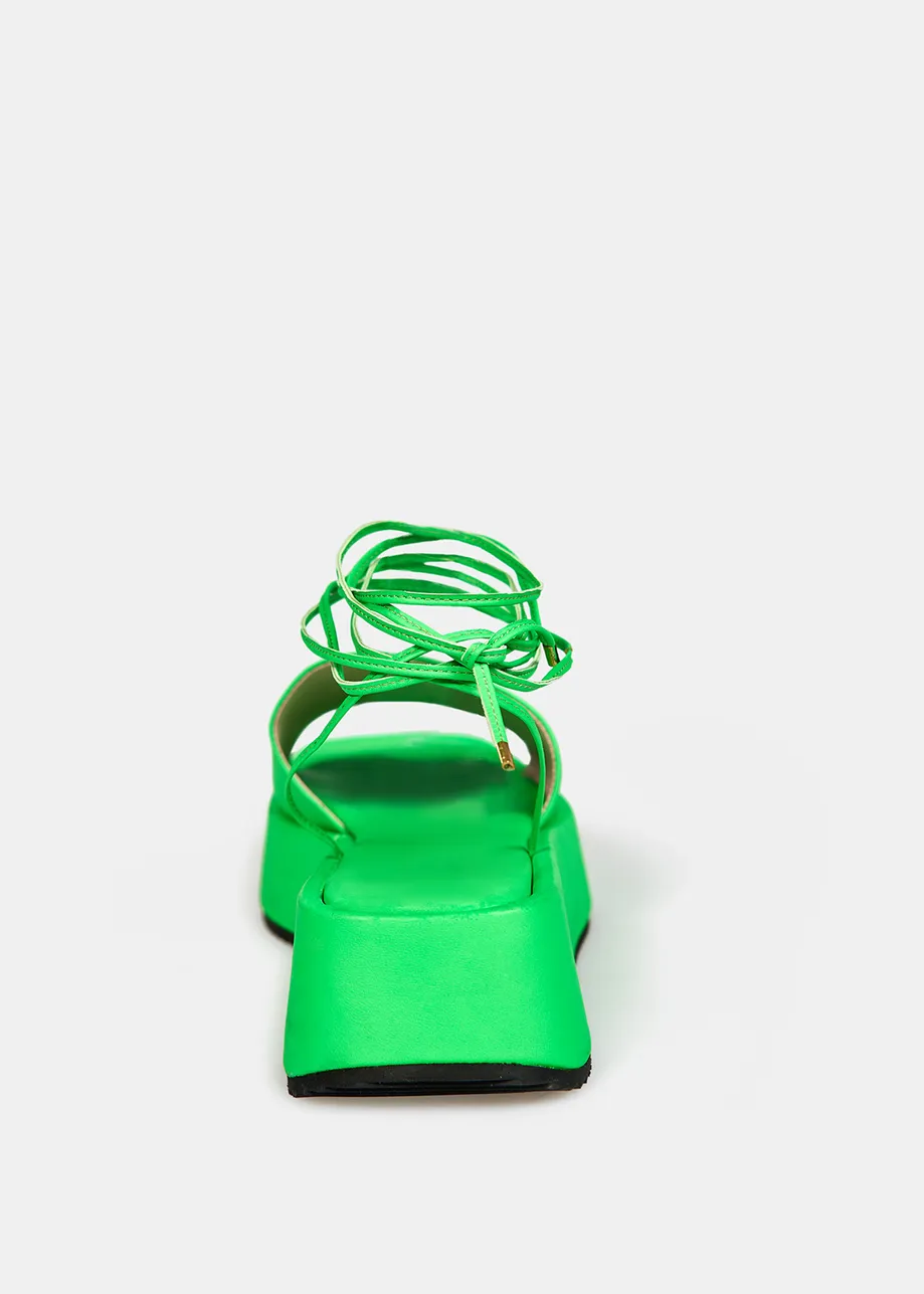 Neon green leather platform sandals with ankle ties