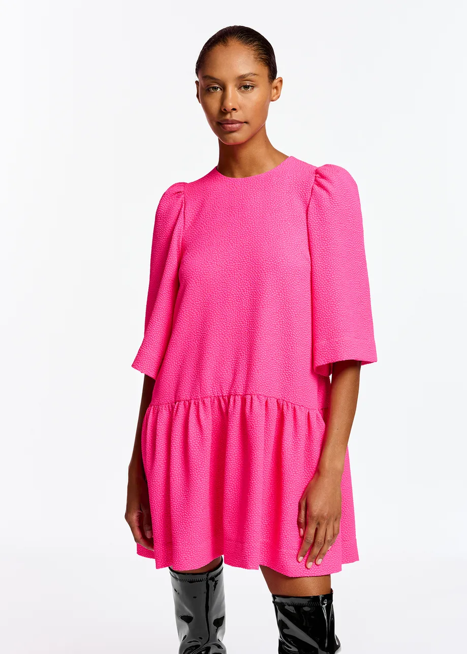 Bright pink mini dress with puffed shoulders