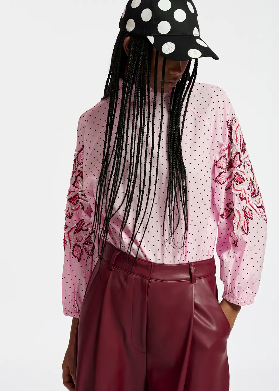 Light pink polka-dotted top with stand-up collar
