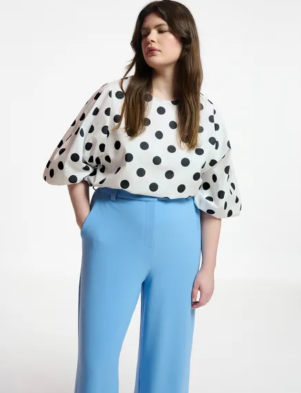 White and black polka-dot top with puffed sleeves