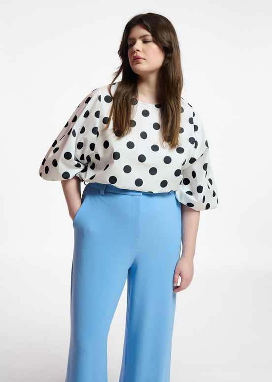 White and black polka-dot top with puffed sleeves