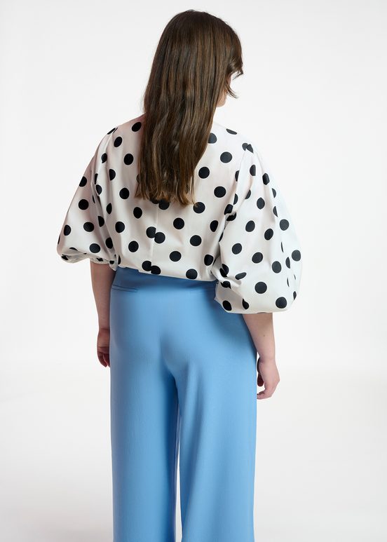 White and black polka-dot top with puffed sleeves