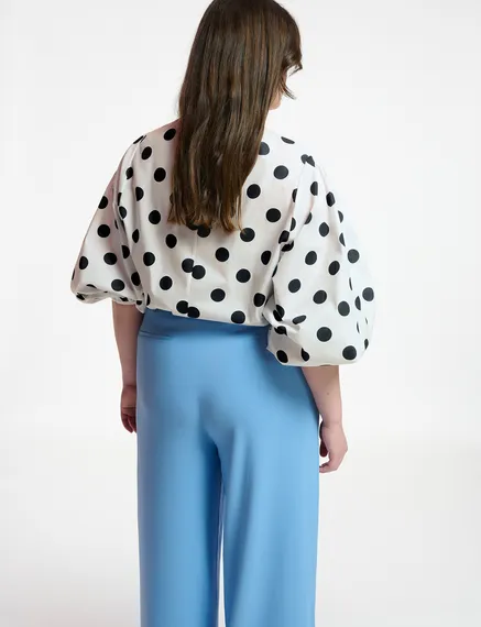 White and black polka-dot top with puffed sleeves