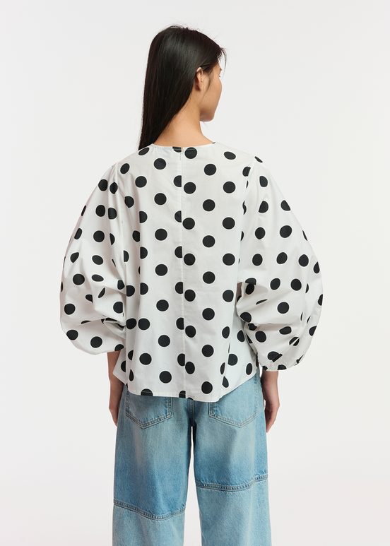 White and black polka-dot top with puffed sleeves