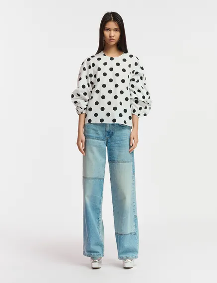 White and black polka-dot top with puffed sleeves