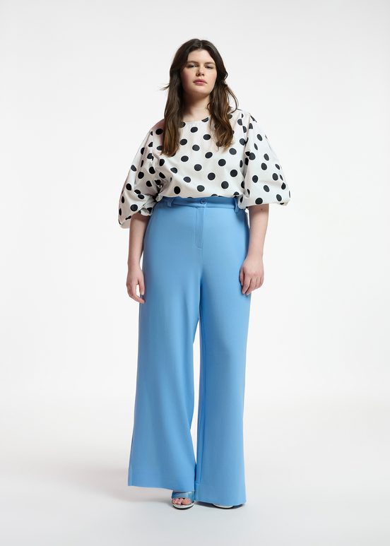 White and black polka-dot top with puffed sleeves