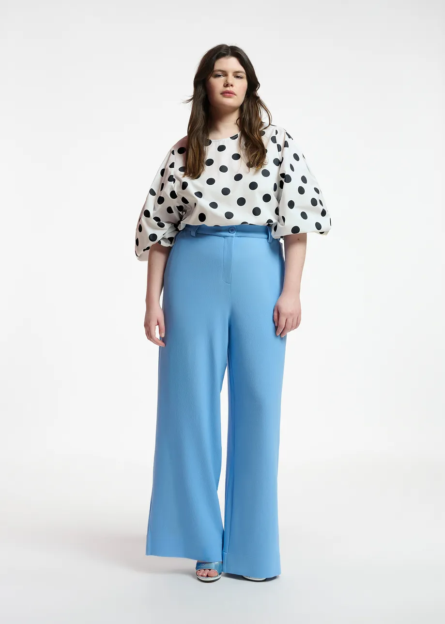 White and black polka-dot top with puffed sleeves