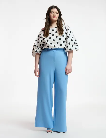 White and black polka-dot top with puffed sleeves