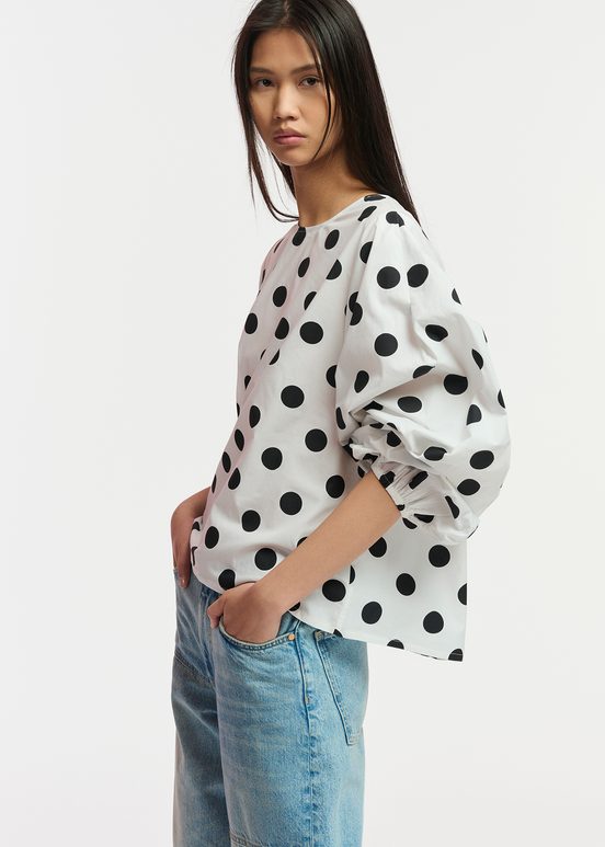 White and black polka-dot top with puffed sleeves