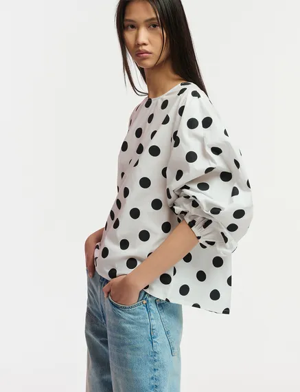 White and black polka-dot top with puffed sleeves