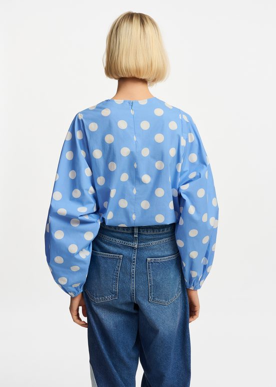 Blue and white polka-dot top with puffed sleeves