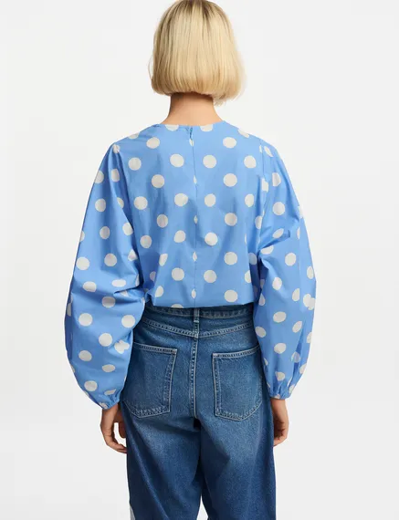 Blue and white polka-dot top with puffed sleeves