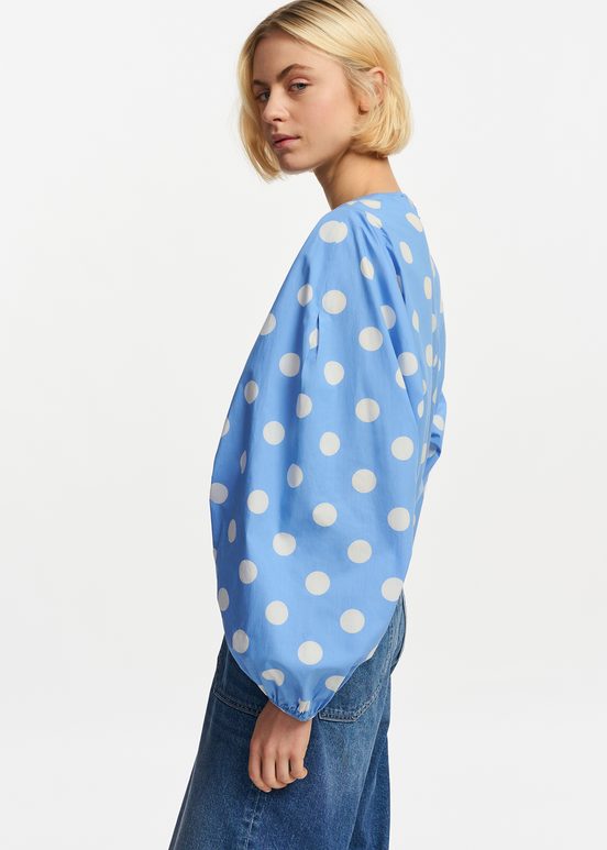 Blue and white polka-dot top with puffed sleeves