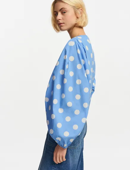 Blue and white polka-dot top with puffed sleeves