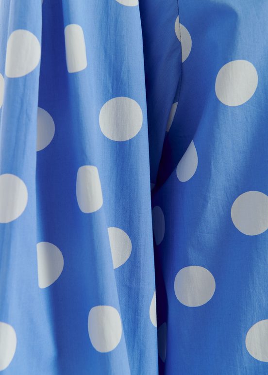 Blue and white polka-dot top with puffed sleeves