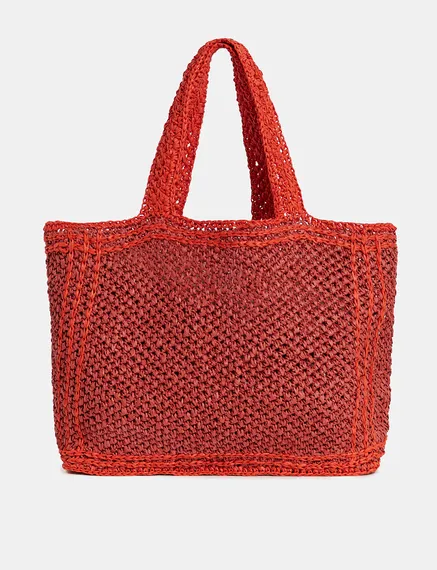 Baksteenrode en oranje shopper in papieren raffia