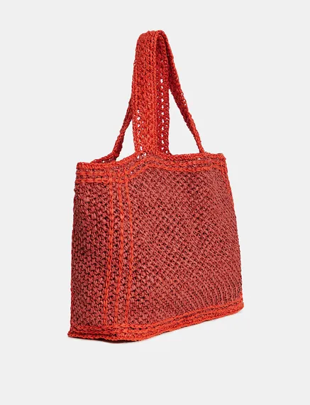 Baksteenrode en oranje shopper in papieren raffia