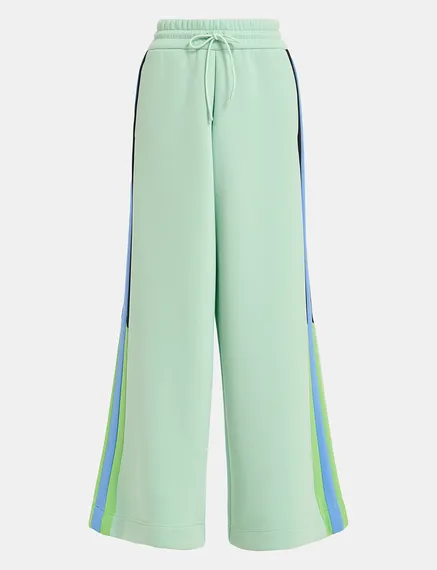 Mint green track pants with black and blue stripes