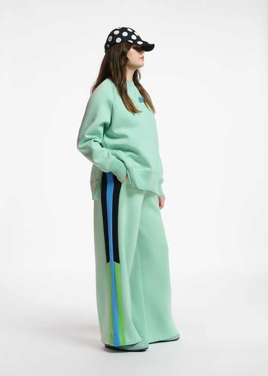 Mint green track pants with black and blue stripes