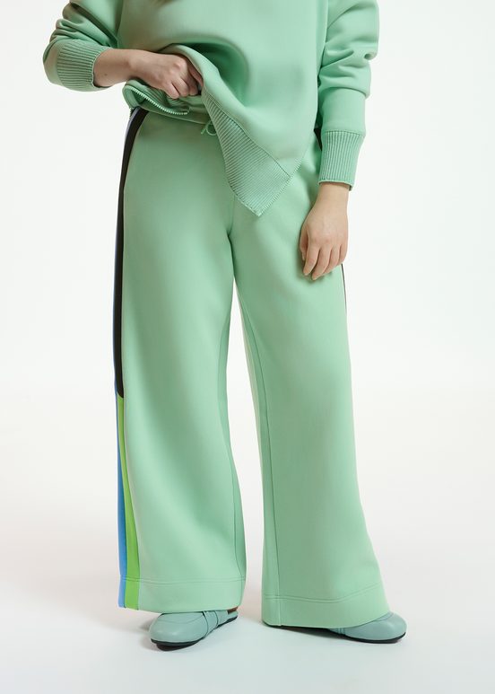 Mint green track pants with black and blue stripes