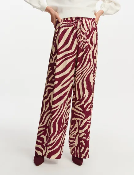 Burgundy and ecru zebra-print wide-leg pants