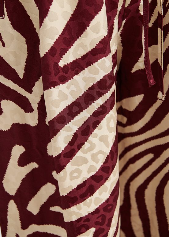 Burgundy and ecru zebra-print wide-leg pants