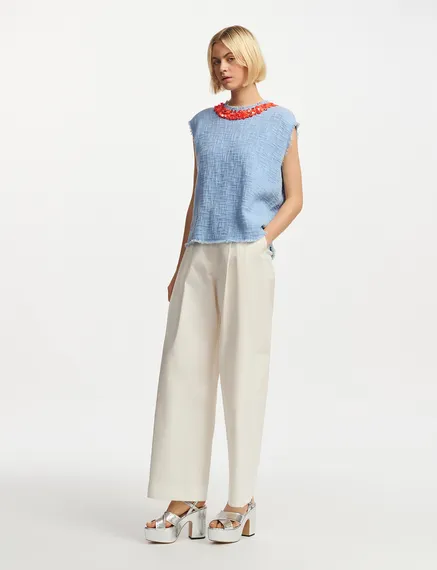 Light blue sleeveless top with sequin and bead-embellished neckline