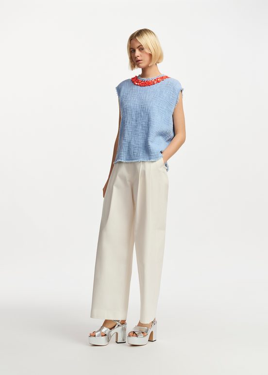 Light blue sleeveless top with sequin and bead-embellished neckline