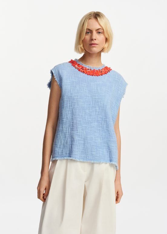 Light blue sleeveless top with sequin and bead-embellished neckline