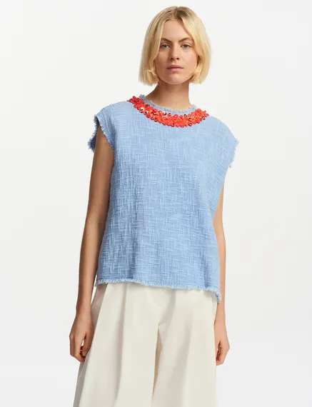 Light blue sleeveless top with sequin and bead-embellished neckline