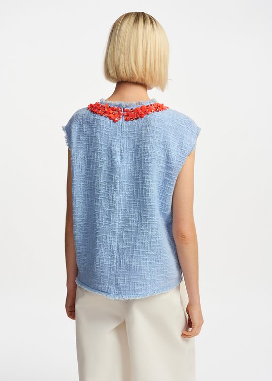 Light blue sleeveless top with sequin and bead-embellished neckline