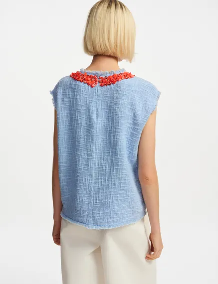 Light blue sleeveless top with sequin and bead-embellished neckline