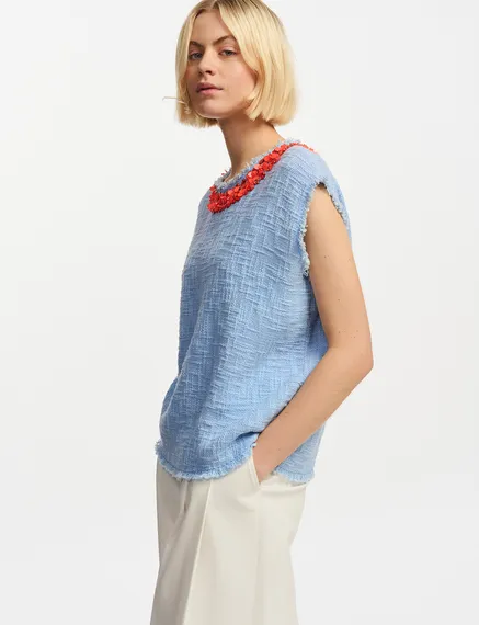 Light blue sleeveless top with sequin and bead-embellished neckline