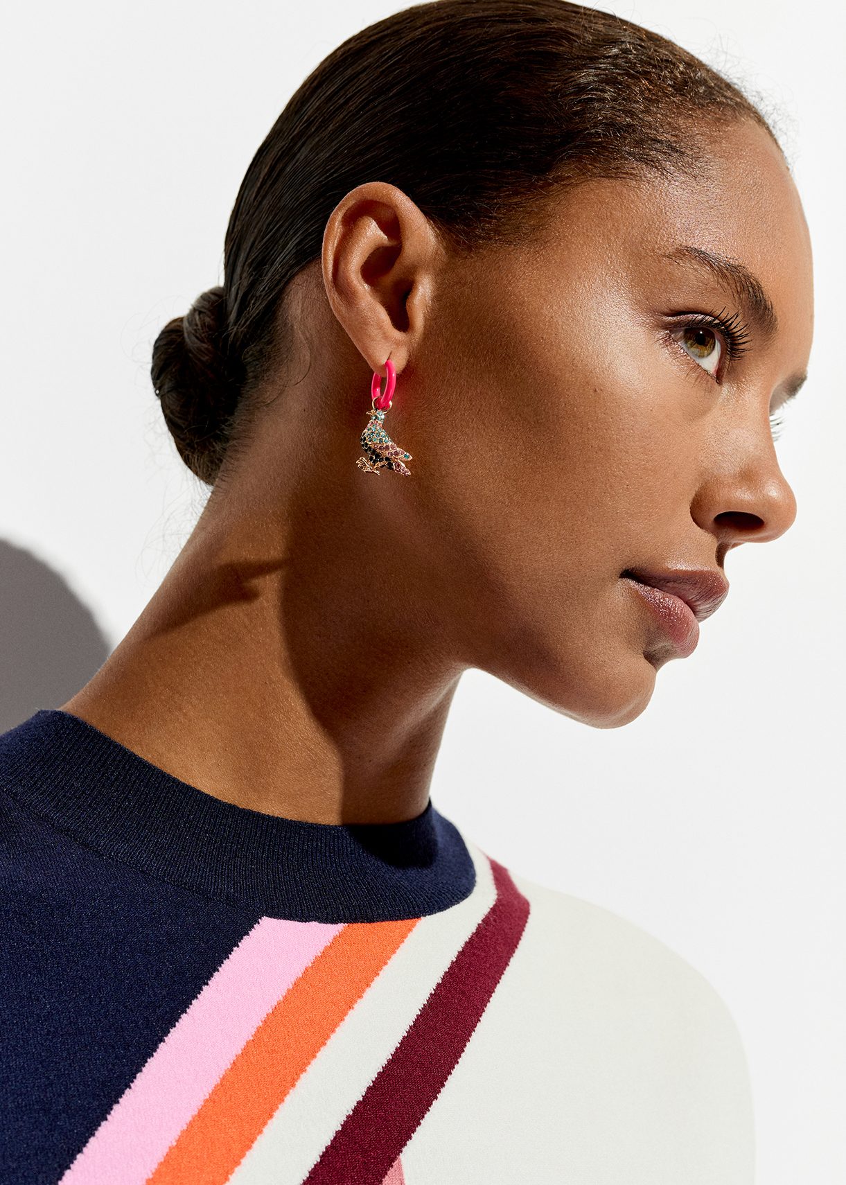 Neon pink hoop earrings with pigeon and peg pendants