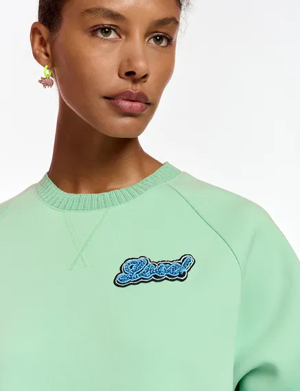 Mint green sweatshirt with bead embellishment