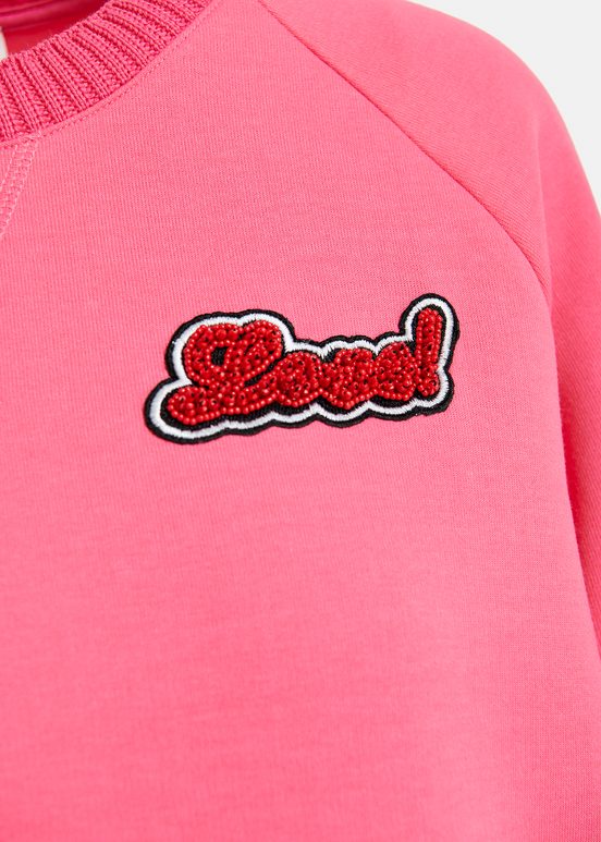 Pink sweatshirt with bead embellishment